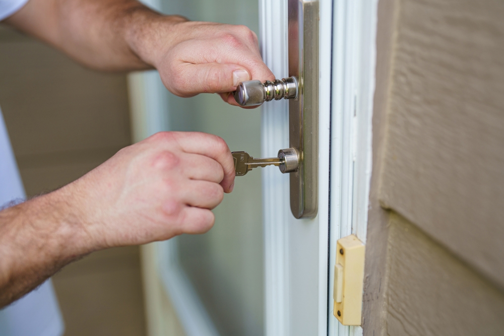 Hands inserting a key into a door lock, illustrating home lockout assistance by Swift Locksmith in Raleigh, NC.